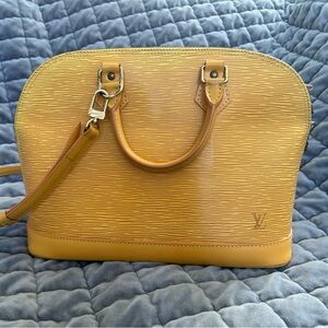 Authentic Louis Vuitton Alma in mustard yellow epi leather with strap. PM size.